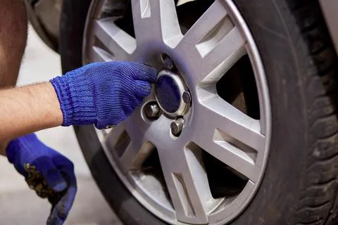 Changing of tires on the car with tools close up. Seasonal work. Safety concept Stock Photos