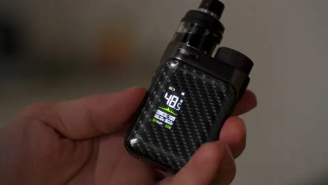 Changing wattage on an electronic cigarette Stock Footage 156938588