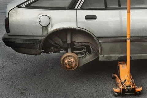 Changing a wheel Jack. the car without wheels, repair of brake disc Stock Illustration