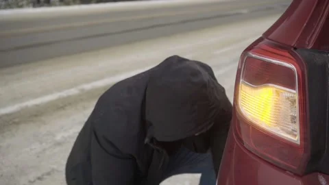Changing a wheel on the road in winter Stock Footage 143450888