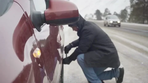 Changing a wheel on the road in winter Stock Footage 143450908
