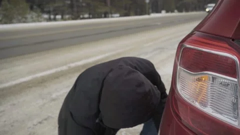 Changing a wheel on the road in winter Stock Footage 143601171