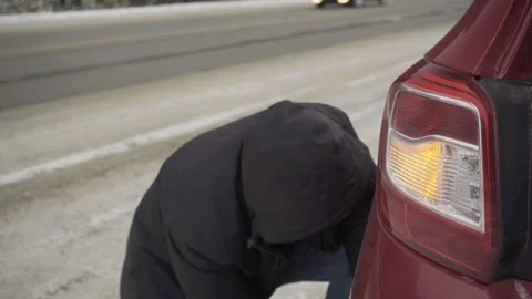 Changing a wheel on the road in winter Stock Footage 144980549