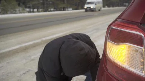 Changing a wheel on the road in winter Stock Photos