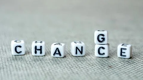 Changing white cubes with word "change" to "chance" on grey background Stock Photos