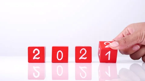 Changing year end 2021 to 2022. Close-up hand turns wooden cubes block 스톡 동영상 164104400