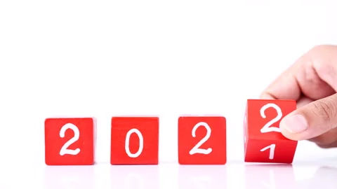 Changing year end 2021 to 2022. Close-up hand turns wooden cubes block Stock Footage 164104610