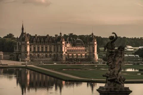 Chantilly castle panoramic view on sunset background Stock Photos