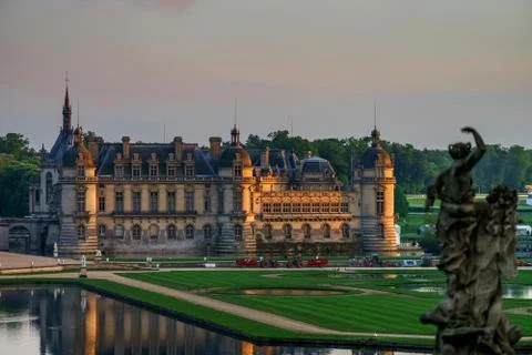 Chantilly castle panoramic view on sunset background Stock Photos
