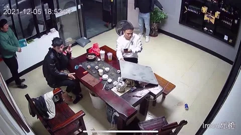 Chaos as cat falls through ceiling at Chinese shop, knocking cups of tea off Stock Footage 272886187