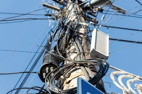 Chaos of many different data cables and network wires messy tangled hanged on Stock Photos