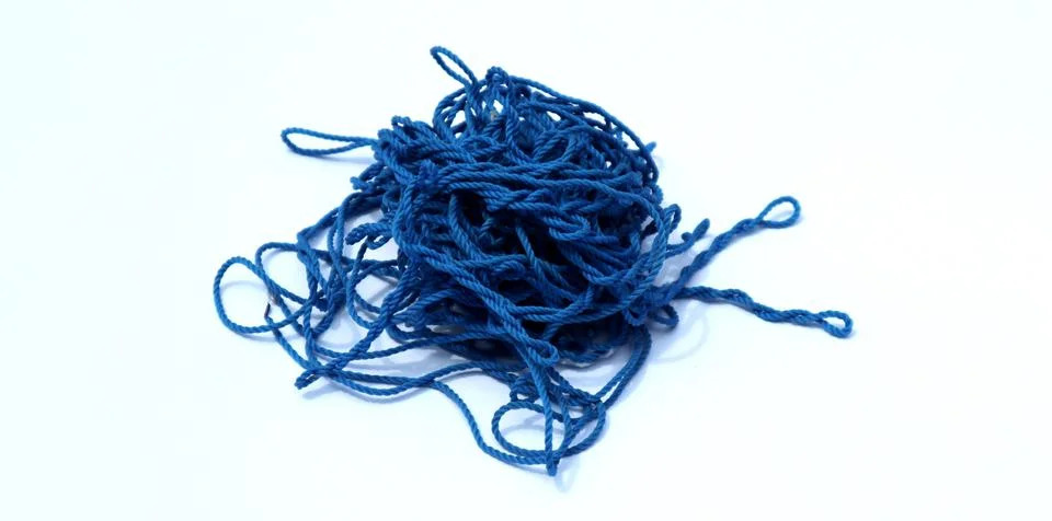 Chaotic blue threads into an irregular circle on a white background Stock Photos