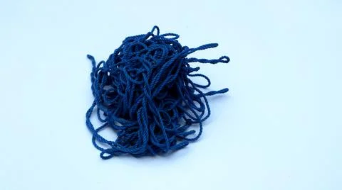 Chaotic blue threads into an irregular circle on a white background Stock Photos