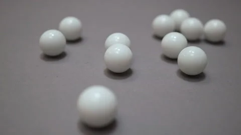 Chaotic collisions of white balls on gray suface Stock Footage 147109044
