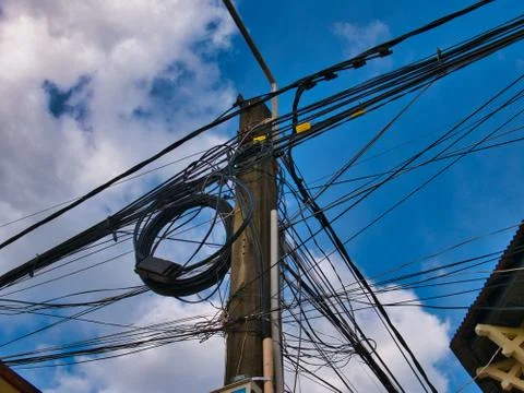 Chaotic electrical supply cabling on a pole on a street in Kampot, Cambodia Stock Photos