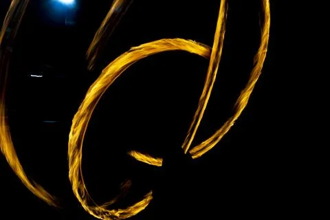 Chaotic lines of fire in dark. Movement of flames on black background. Stock Photos