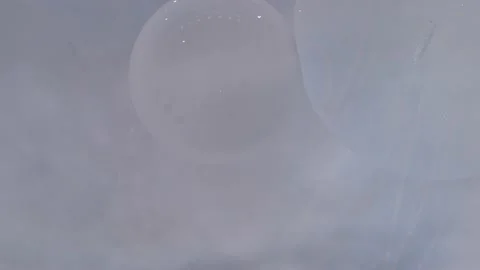 Chaotic movement, expansion of the bubble flow, swirls of white colors. Stock Footage 212995551