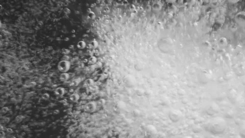 Chaotic moving pattern of white bright bubble isolated on black background Stock Footage 242274146