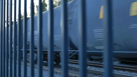 Chaotic shot of train moving away through gate Stock Footage 118463887
