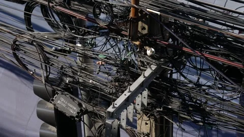 Chaotic tangle of electrical and fiber optic cables Видео 331494227