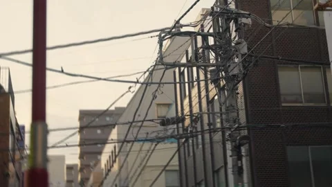 Chaotic tangled electricity cables and telephone wires on a pole in Tokyo, Japan Stock Footage 340644678