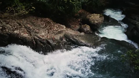 Chaotic turbulent water flow, Vigorous waves and froth engaging with jagged Stock Footage 343948133