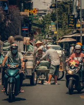 A chaotic, vibrant, and authentic street scene in Ho Chi Minh, Vietnam, showing Stock-Fotos
