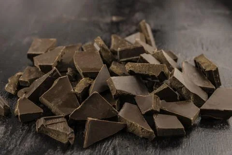 Chaotically broken dark chocolate bars Stock Photos