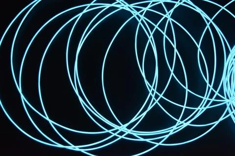 Chaotically celestial, light blue, neon harness, illuminated wire, thin wire. Fotos de archivo
