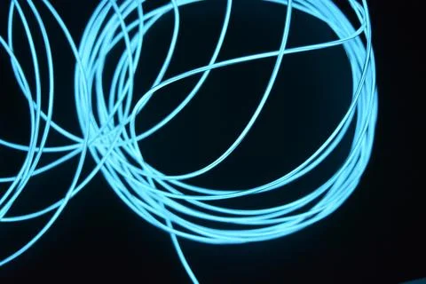 Chaotically celestial, light blue, neon harness, illuminated wire, thin wire. Fotos de archivo