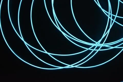 Chaotically celestial, light blue, neon harness, illuminated wire, thin wire. Fotos de archivo