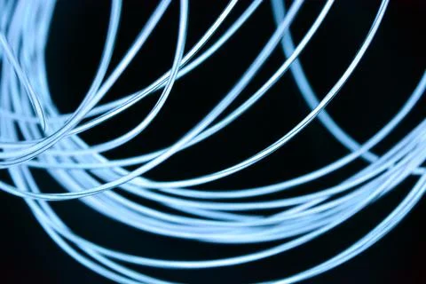 Chaotically celestial, light blue, neon harness, illuminated wire, thin wire. Stock Photos