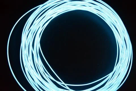 Chaotically celestial, light blue, neon harness, illuminated wire, thin wire. Fotos de archivo