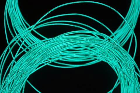 Chaotically celestial, light blue, neon harness, illuminated wire, thin wire. Stock Photos
