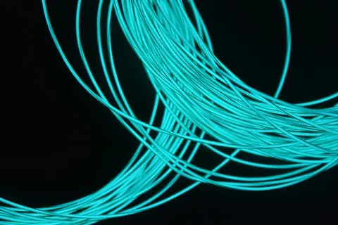 Chaotically celestial, light blue, neon harness, illuminated wire, thin wire. Stock Photos