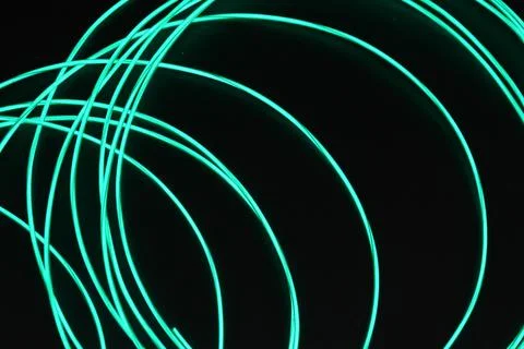 Chaotically celestial, light blue, neon harness, illuminated wire, thin wire. Stock Photos