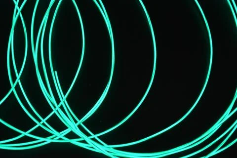Chaotically celestial, light blue, neon harness, illuminated wire, thin wire. Stock Photos