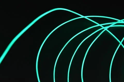Chaotically celestial, light blue, neon harness, illuminated wire, thin wire. Stock Photos