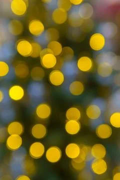 Chaotically placed bokeh circles shine with festive lights. Stock Photos