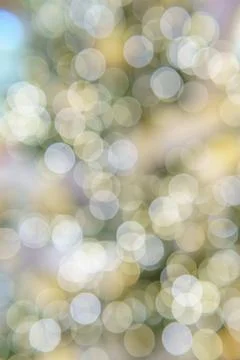 Chaotically placed bokeh circles shine with festive lights. Stock Photos