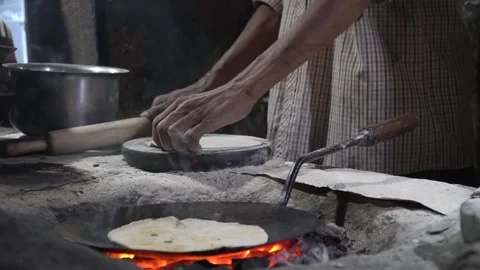 Chapati baking on fire close-up traditional Indian street food delights Stock-Footage 310942378