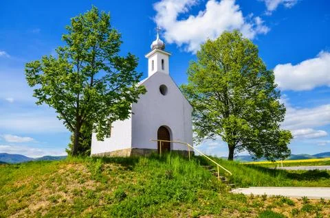 Chapel in beautiful sunny spring day - green trees and clear blue sky Stock Photos