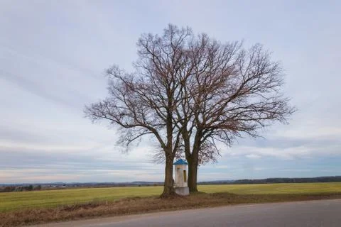 Chapel between two trees. Sky with clouds Stock Photos