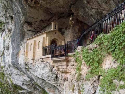 Chapel built in a cave at Picos de Europa mountain Stock Photos