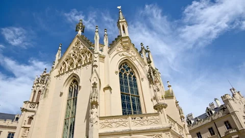 The chapel of Lednice Castle with tall stained-glass windows and slender Video stock 342230713