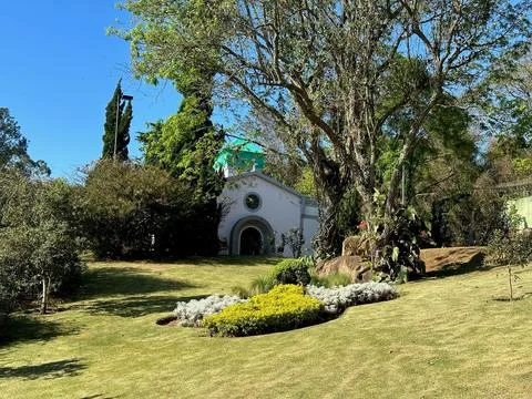 Chapel in a lush garden setting Stock Photos