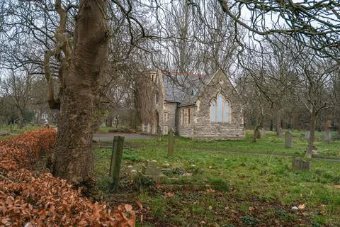 Chapel nestled among bare trees Stock Photos
