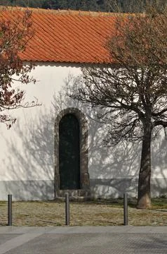 Chapel side door with a tree shadow Stock Photos