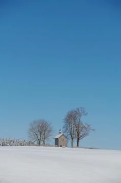 Chapel in winter landscape Stock Photos