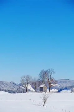 Chapel in winter landscape Stock Photos